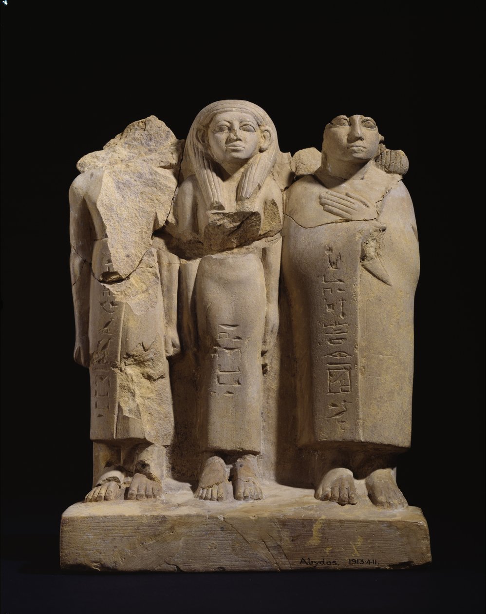Gruppenstatuette von 3 Figuren, späte 12. Dynastie - frühe 13. Dynastie, ca. 1800-1700 v. Chr. (geschnitzter gelber Sandstein mit Spuren von roter und schwarzer Farbe) von Egyptian