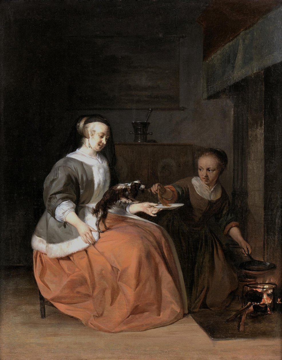 Junge Frau und Dienstmädchen füttern einen Hund mit einem Pfannkuchen von Gabriel Metsu