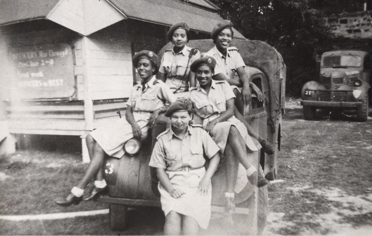 Fünf Mitglieder des West Indies Auxiliary Territorial Service sitzen auf einem Militärfahrzeug von Unbekannt