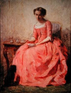 Mädchen im rosa Kleid an einem Tisch