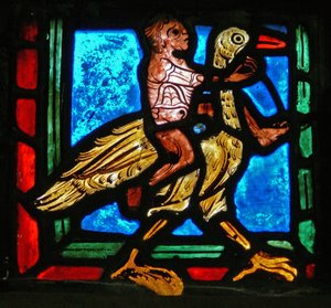 Eckstück eines Fensters, das das Gleichnis vom barmherzigen Samariter darstellt: Mann und Vogel