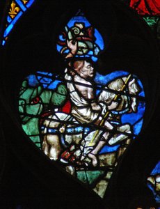 Das westliche Rosenfenster zeigt eine Szene aus dem Buch der Offenbarung: bleiches Pferd mit der grotesken Figur des Todes, bewaffnet mit einem Speer und Vipern. Er taucht aus dem riesigen grünen Maul der Hölle auf. von French School