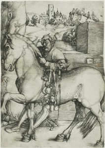 Ein Stallknecht zäumt ein Pferd