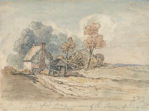 Ein strohgedecktes Cottage und Bäume an einer Landstraße