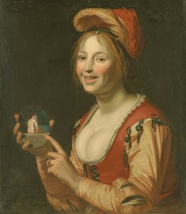 Lachendes Mädchen zeigt ein kleines Bild einer nackten Frau von hinten