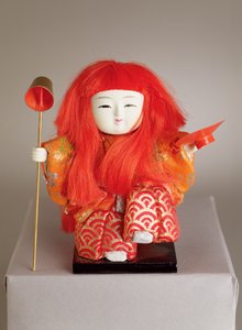 Festpuppe eines Dieners, der eine Kelle und eine Schale hält