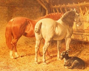 Pferde und eine Ziege in einem Stall