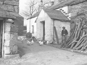 Landmädchen füttert Geflügel auf einem Bauernhof in Ulpha in den Duddon Fells