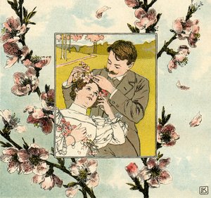 Mann steckt Frühlingsblüte in das Haar einer jungen Frau