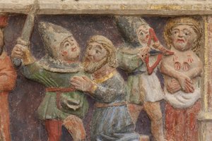 Altarbild. Polychromer Stein. Zweite Hälfte des 14. Jahrhunderts. Ursprung ehemalige Pfarrkirche von Torre de Rialb. Detail. Mittleres Register. Linkes Panel. Unterer Teil: Ein Beamter beobachtet die Szene der Enthauptung von Saint Iscle und der Amputation von Unbekannt