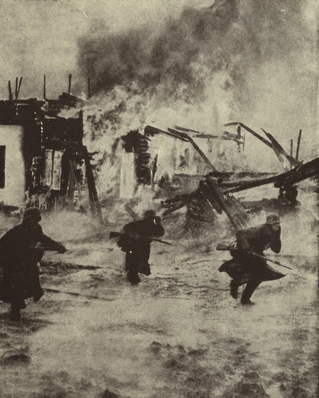 Deutsche Soldaten marschieren durch die brennenden Ruinen von Rotterdam nach der Bombardierung durch die Luftwaffe, Zweiter Weltkrieg, Mai 1940 von Photographer German