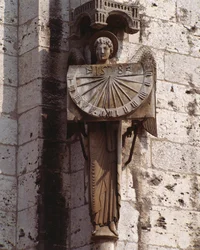 Gotische Kunst: Darstellung des Engels auf der Sonnenuhr. Skulptur des 20. Jahrhunderts nach einem Original des 16. Jahrhunderts, aufbewahrt in der Krypta, südwestliche Ecke der Basilika Notre Dame de Chartres (Eure et Loir)