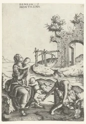 Familie sitzt am Wasserufer in der Nähe einer Ruine