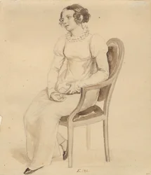 Eine Dame, die in einem Sessel sitzt, zum Fenster gewandt