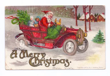 Edwardianische Weihnachtskarte von Weihnachtsmann, der ein Oldtimer-Auto durch den Schnee fährt, ca. 1910