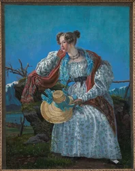Junge Frau, die in einer norwegischen Landschaft sitzt