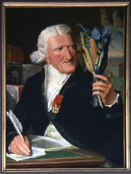 Parmentier hält die Knolle und die Kartoffelblüte