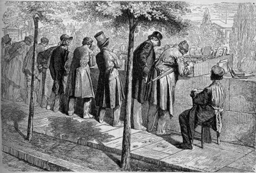 Ein "Bouquiniste" (Buchverkäufer) an den Ufern der Seine in Paris