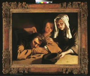 Ein Kerzenlicht-Interieur mit Figuren um einen Tisch