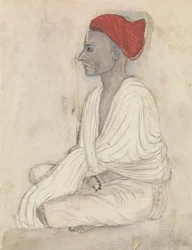 Mann mit rotem Turban im Schneidersitz