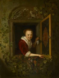 Mädchen mit einem Traubenstrauß am Fenster