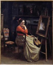 Eine nachdenkliche junge Frau mit einer Mandoline in der Hand im Atelier des Malers