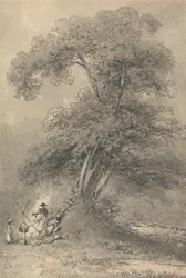 Eine Familie kocht unter einem Baum