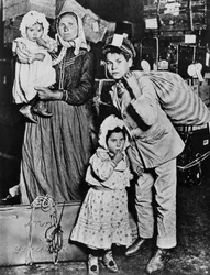 Einwanderer, die zu Beginn des 20. Jahrhunderts auf Ellis Island ankommen (s/w Foto)