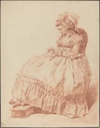 Sitzende Frau beim Nähen