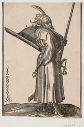 Stehender Soldat (akinci), Profil nach rechts; in der rechten Hand eine Keule, in der linken Hand eine Lanze, deren Spitze außerhalb der oberen Rahmenlinie ist; auf dem linken Arm ein Schild mit der Innenseite nach oben, an der linken Seite ein Schwert