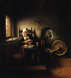 Alte Frau beim Apfelschälen