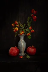 Verblasste Rosen und Granatäpfel
