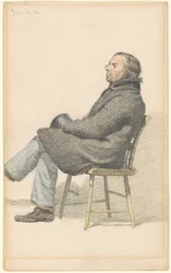 In einem Hitchcock-Stuhl sitzender Mann