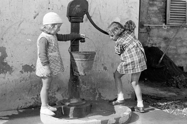 Kleine Mädchen füllen einen Wassereimer, 9. Mai 1939